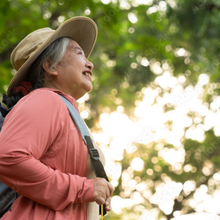 Elderly woman smiling while forest bathing